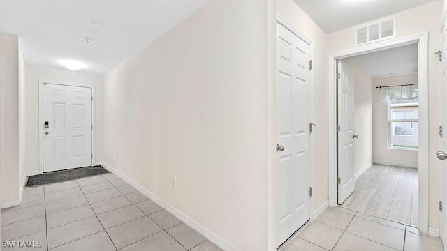 corridor with light tile patterned flooring