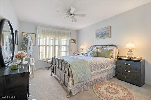 bedroom with ceiling fan and light carpet