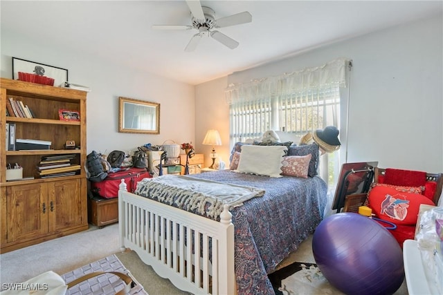 bedroom with ceiling fan and light carpet