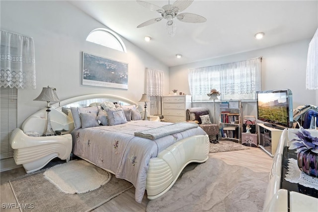 bedroom featuring ceiling fan, light hardwood / wood-style flooring, and vaulted ceiling