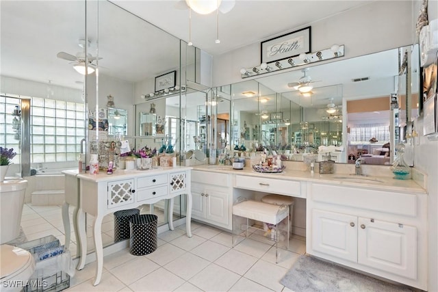 bathroom with tile patterned flooring, vanity, and ceiling fan