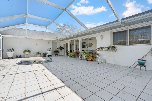 view of patio / terrace featuring glass enclosure and ceiling fan