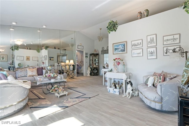 living room featuring light hardwood / wood-style flooring and vaulted ceiling