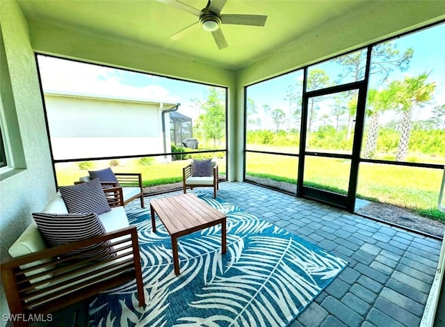 sunroom / solarium featuring ceiling fan