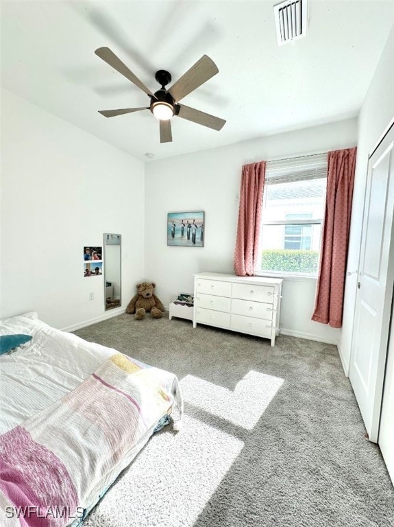 carpeted bedroom featuring ceiling fan and a closet