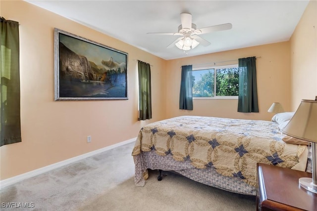 bedroom featuring light colored carpet and ceiling fan