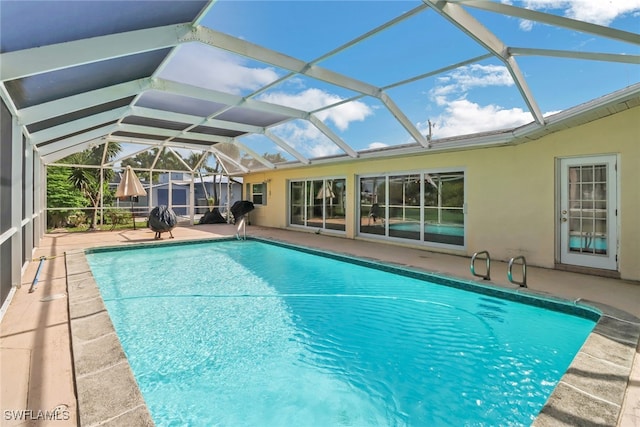 view of swimming pool featuring a patio and a lanai