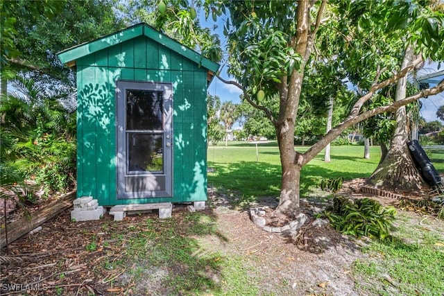 view of outbuilding with a lawn