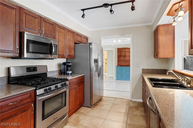 kitchen with ornamental molding, sink, appliances with stainless steel finishes, and track lighting