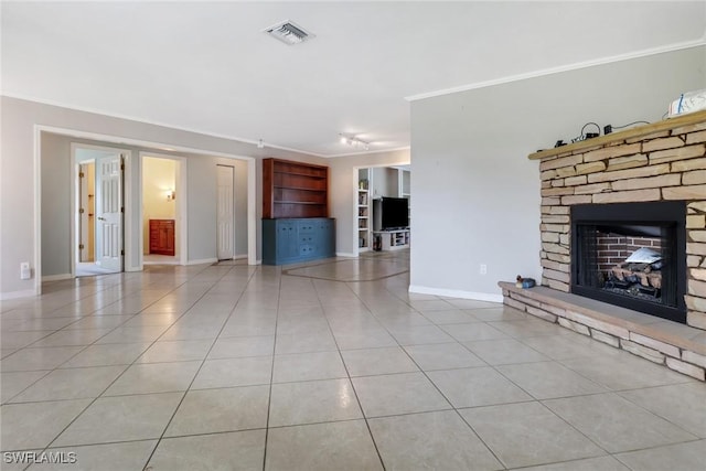 unfurnished living room with a fireplace, light tile patterned floors, and ornamental molding