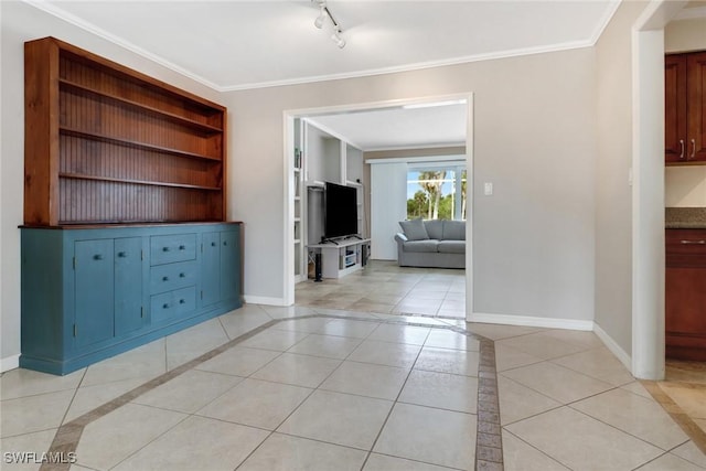 interior space with light tile patterned flooring and crown molding