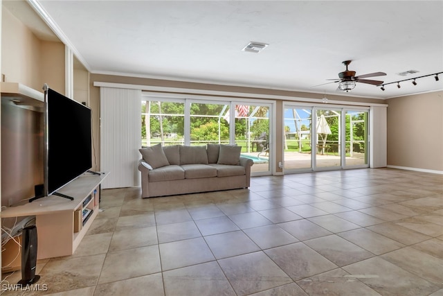 unfurnished living room with plenty of natural light, ceiling fan, ornamental molding, and light tile patterned floors