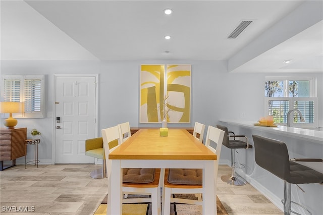 dining room with sink and light hardwood / wood-style floors