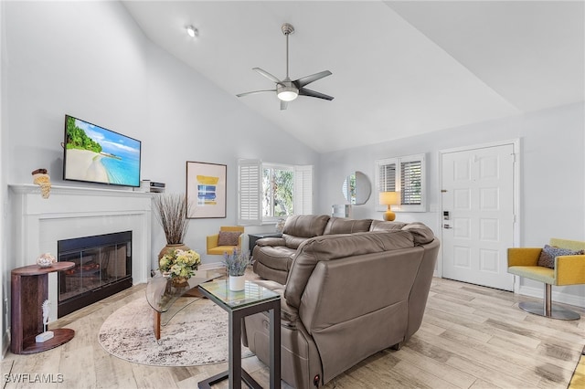 living room featuring ceiling fan, high vaulted ceiling, and light hardwood / wood-style flooring