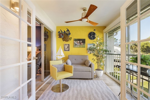 sunroom featuring french doors and ceiling fan