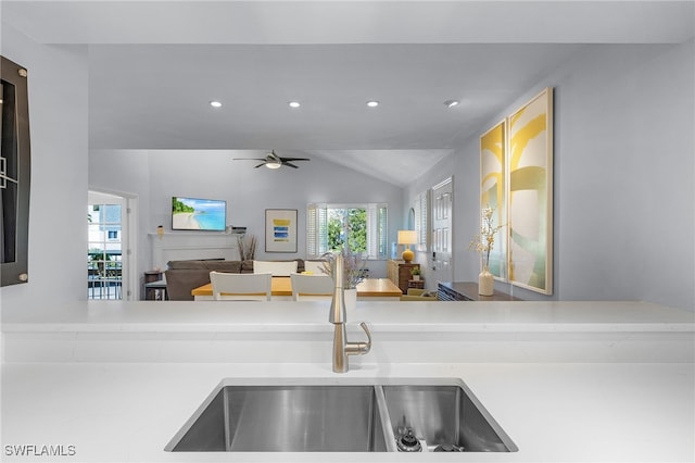 kitchen featuring ceiling fan, sink, and vaulted ceiling