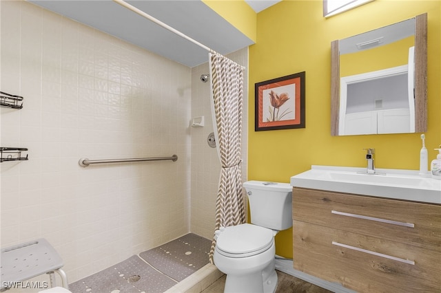 bathroom featuring vanity, toilet, and curtained shower