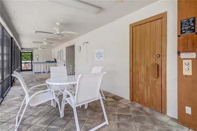 sunroom featuring ceiling fan