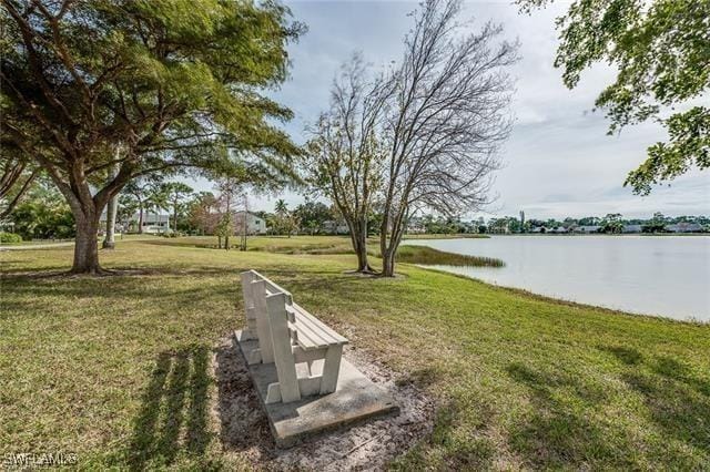 view of community with a yard and a water view