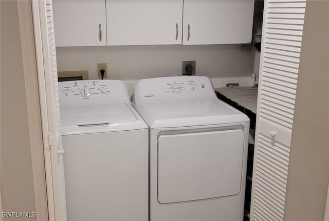 laundry area with cabinets and washing machine and clothes dryer