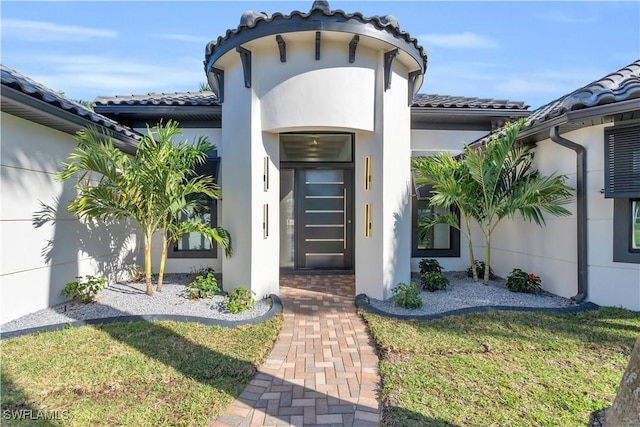 doorway to property with a yard