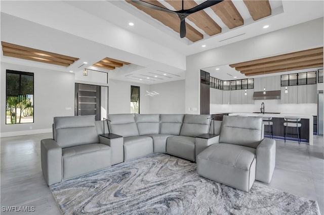 living room with ceiling fan and sink