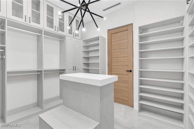 spacious closet with a notable chandelier