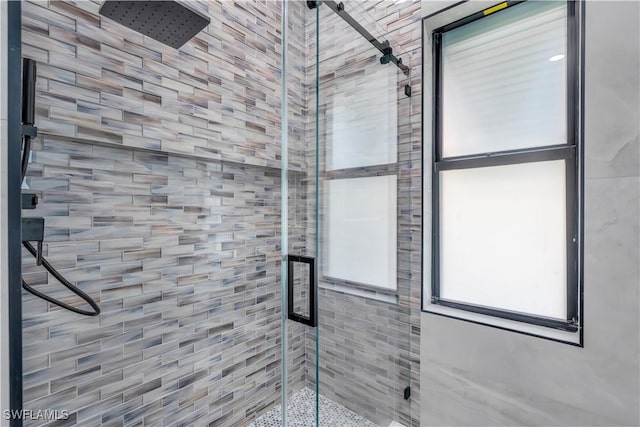 bathroom featuring a shower with door