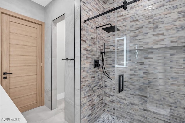 bathroom with a shower with door