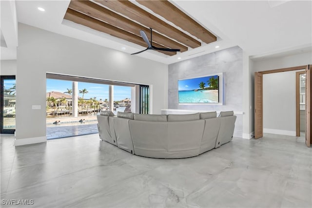 unfurnished living room featuring ceiling fan and a towering ceiling