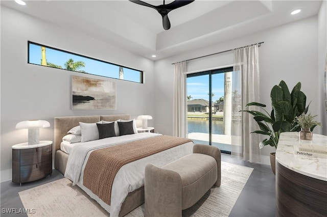 bedroom with concrete flooring, a water view, access to outside, and ceiling fan