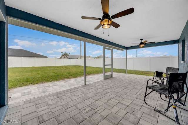 unfurnished sunroom with plenty of natural light and ceiling fan