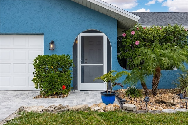 doorway to property with a garage