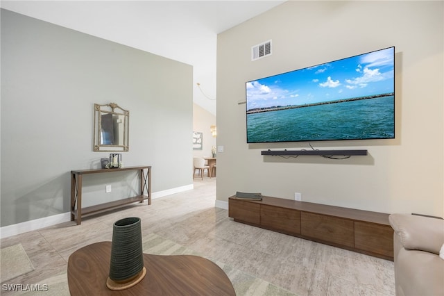 living room featuring lofted ceiling