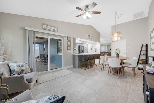 dining space with ceiling fan and lofted ceiling