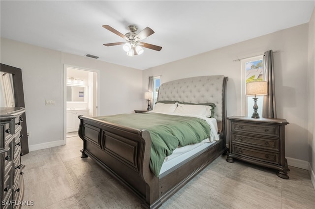 bedroom with ceiling fan and ensuite bath