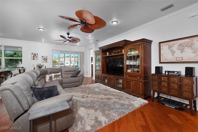 living room featuring crown molding and dark wood-type flooring