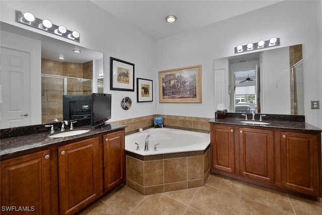 bathroom featuring plus walk in shower, vanity, and tile patterned flooring