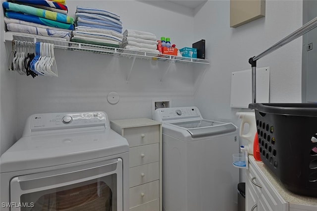 clothes washing area featuring independent washer and dryer