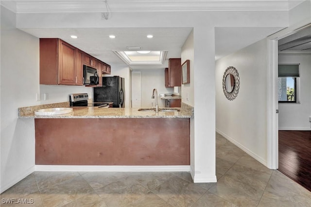 kitchen with kitchen peninsula, light stone countertops, crown molding, black appliances, and sink