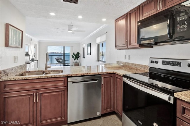 kitchen featuring kitchen peninsula, stainless steel appliances, ornamental molding, and sink