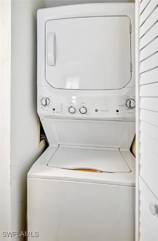 washroom featuring stacked washer and dryer