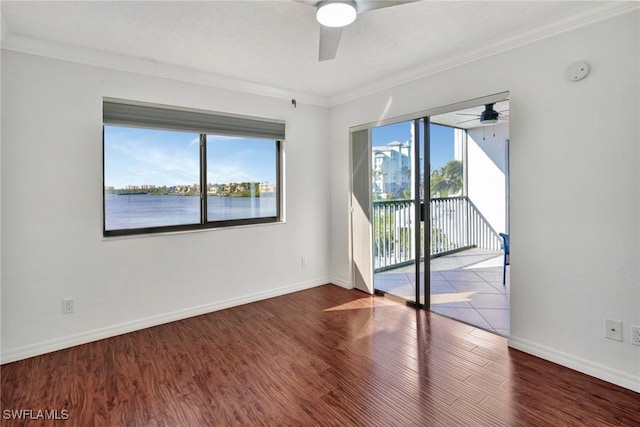 spare room featuring wood-type flooring, a water view, ceiling fan, and crown molding