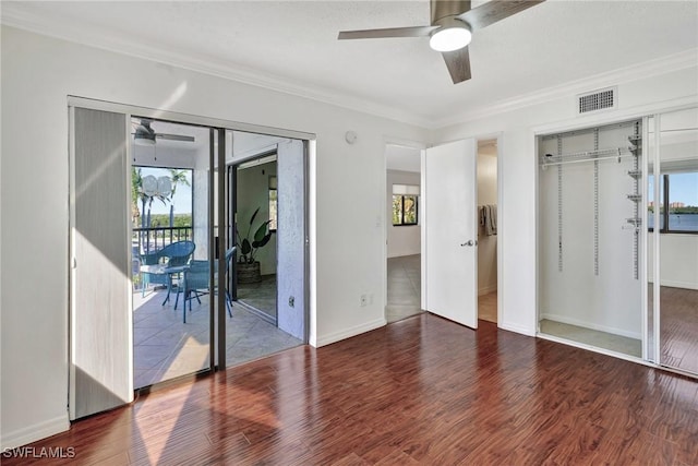 unfurnished bedroom with multiple windows, a closet, and ornamental molding