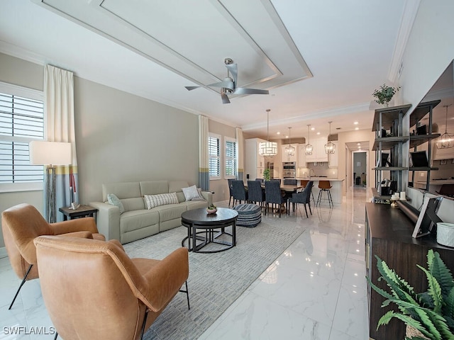 living room with ceiling fan and ornamental molding