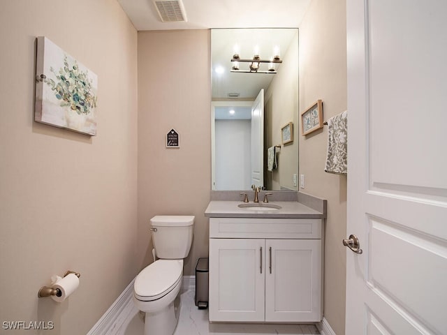 bathroom featuring vanity and toilet