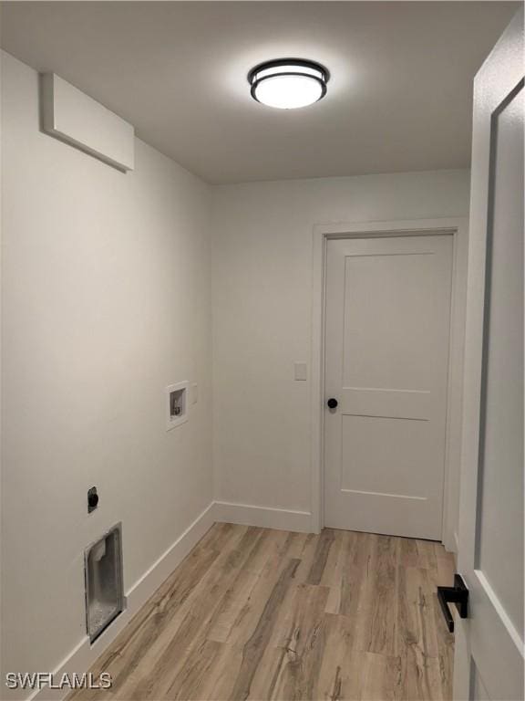 laundry room featuring light hardwood / wood-style flooring and washer hookup