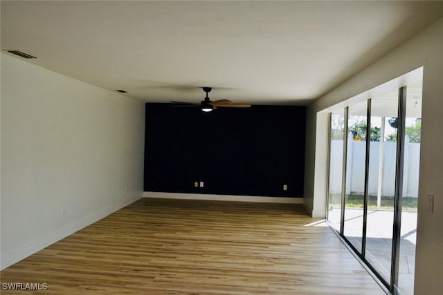 empty room with ceiling fan and light wood-type flooring