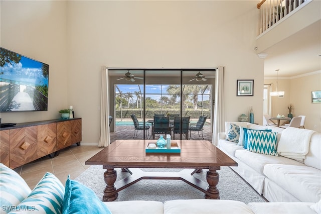 living room featuring crown molding, light tile patterned floors, and an inviting chandelier