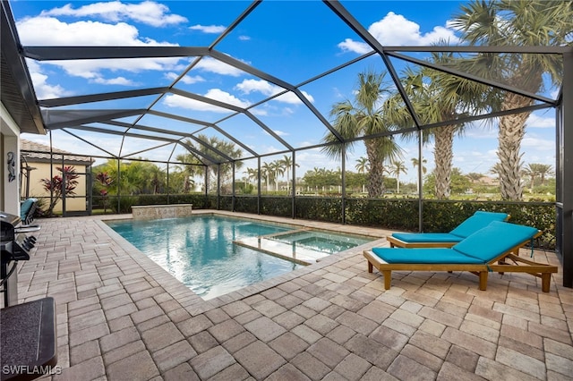 view of pool featuring a lanai, an in ground hot tub, and a patio